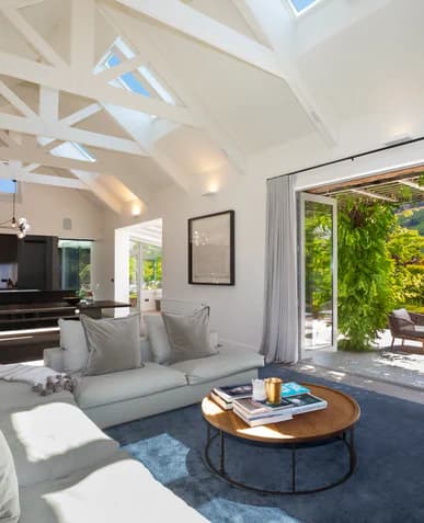 Living room with a sectional sofa and doors to the garden